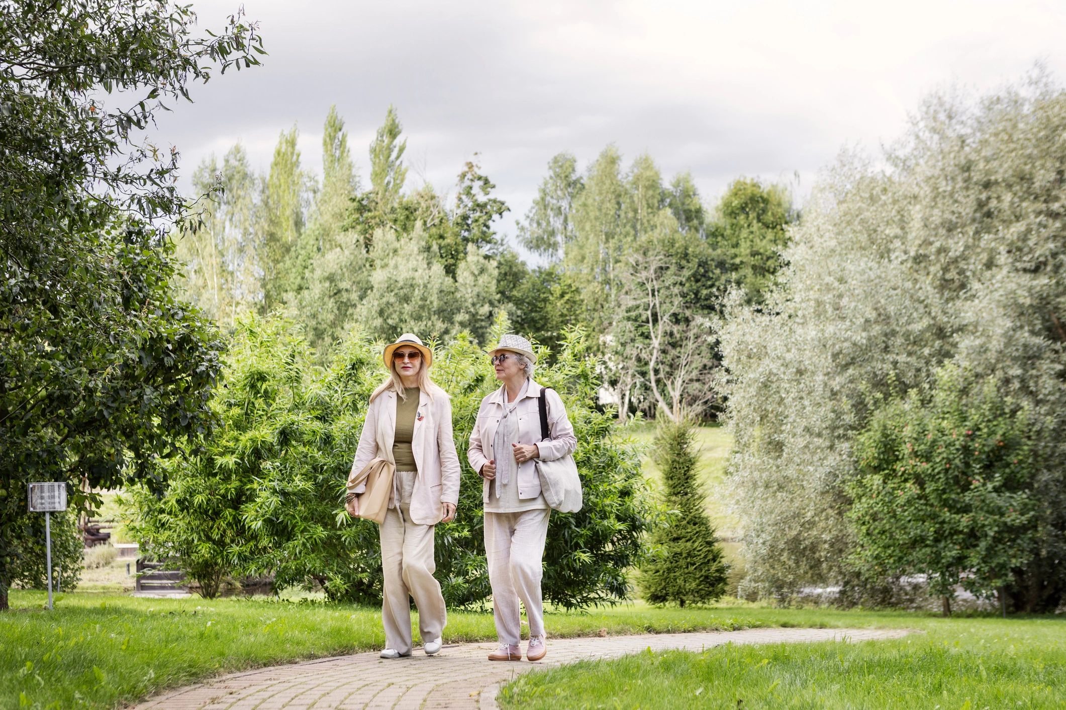 Two senior women enjoying a peaceful walk together outdoors