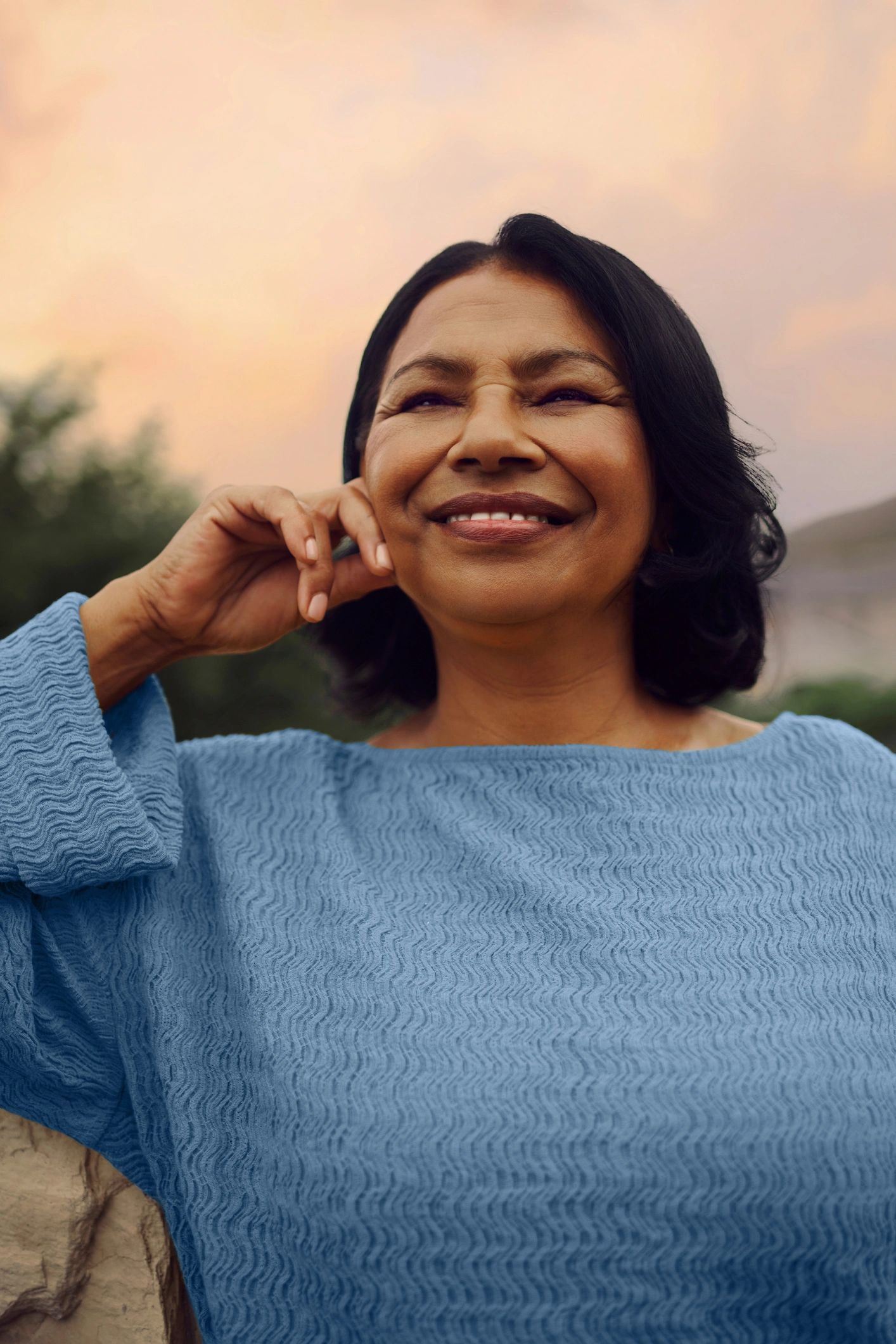 Woman smiling peacefully outdoors