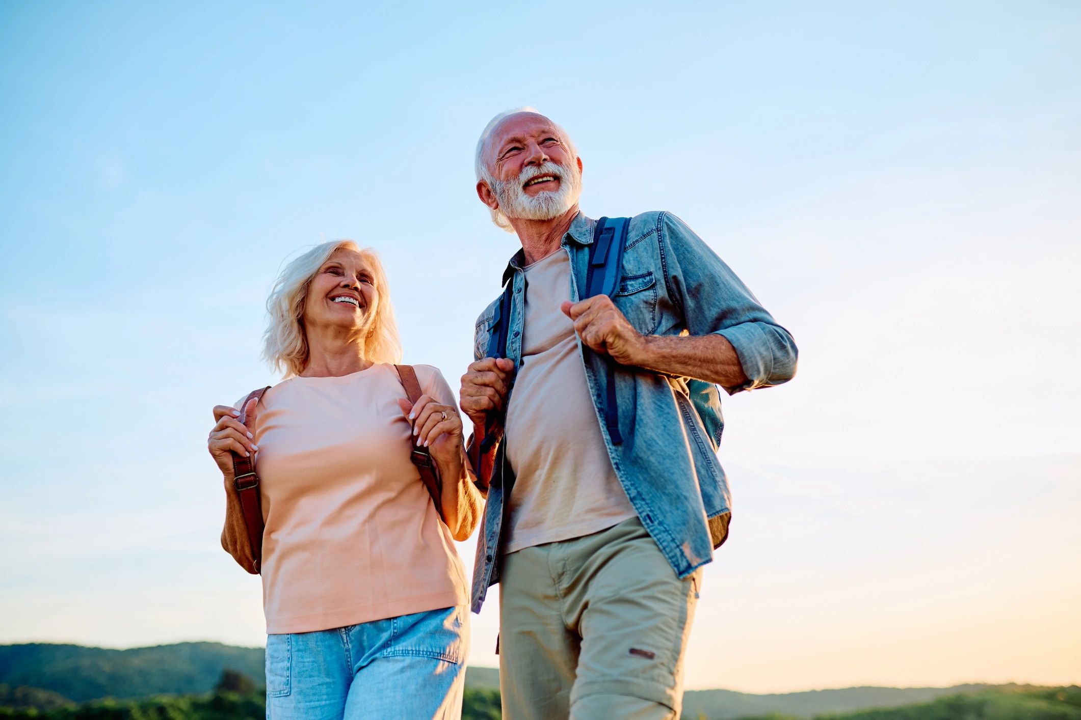 Happy active senior couple enjoying an outdoor walk together